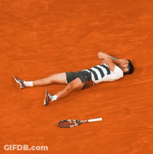 Man Laying On Ground With Tennis Racquet GIF