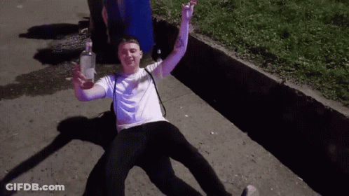 Man Laying On Ground With Vodka Bottle GIF