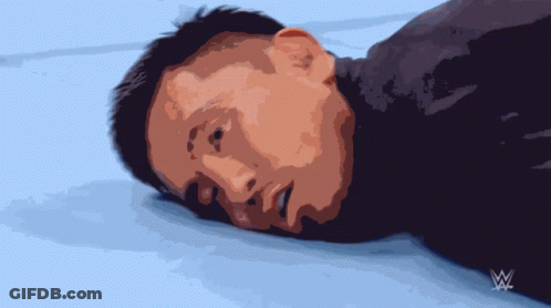Man Laying On Ground With Wrestling Logo GIF