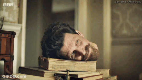 Man Laying On Pile Of Books BBC GIF