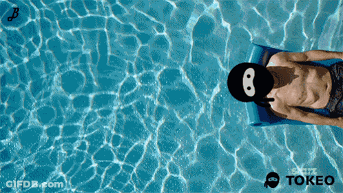 Man Laying On Raft In Pool With Tokeo Logo GIF