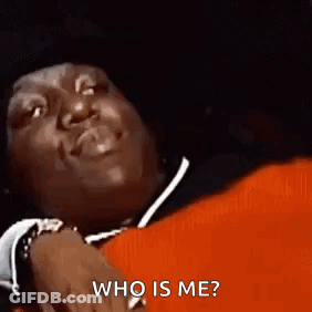 Man Laying On Red Blanket Smiling Asking Who Is Me GIF