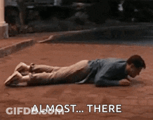 Man Laying On Stomach Saying Almost There GIF