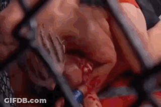 Man Laying On Top Of Another In Cage GIF