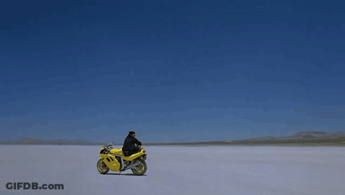 Man Laying On Yellow Motorcycle Number 1 GIF