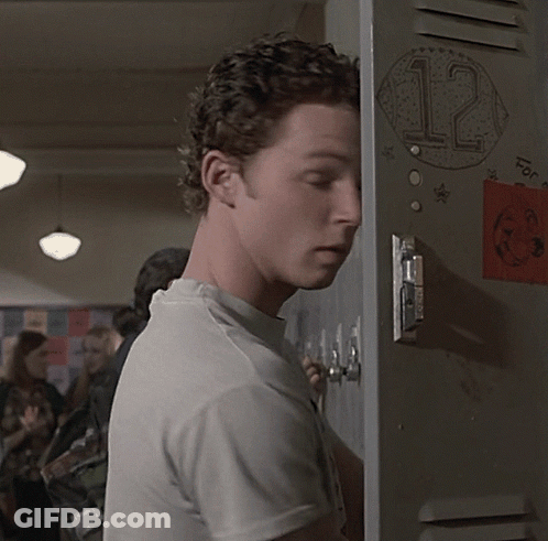 Man Leaning Against Locker With Sticker Saying 12 GIF