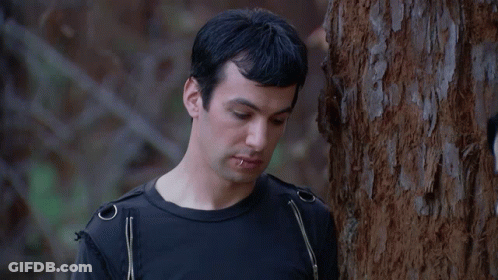 Man Leaning Against Tree In Black Shirt Saying Okay GIF