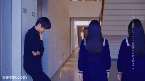 Man Leaning Against Wall In Hallway GIF