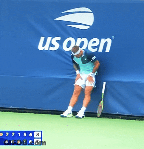 Man Leaning Against Wall With Tennis Racquet GIF