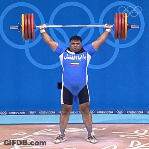 Man Lifting Barbell In Front Of Athens 2004 Signs GIF