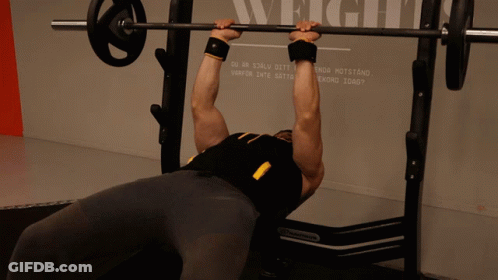 Man Lifting Barbell In Front Of Wall Saying Weight GIF