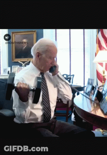Man Lifting Dumbbell Talking On Phone GIF