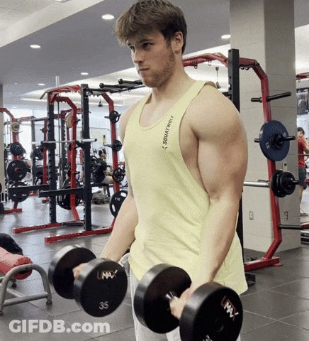 Man Lifting Dumbbells In Yellow Tank Top Saying Squatting GIF