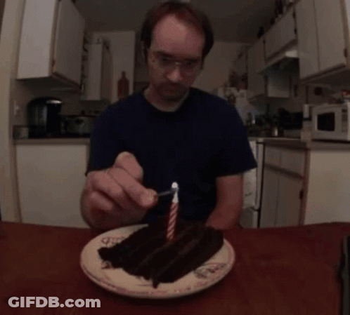 Man Lighting Candle On Cake GIF