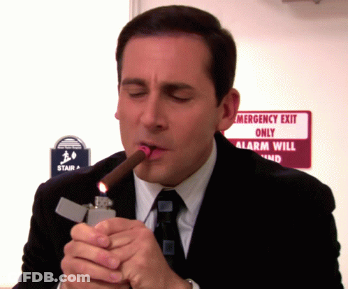 Man Lighting Cigar Near Emergency Exit GIF