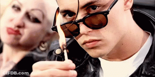 Man Lighting Lighter Next To Woman GIF