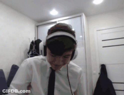 Man Looking At Camera With Headphones And Tie GIF