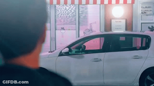 Man Looking At Car Parked By Store With Mini Sign GIF