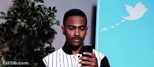 Man Looking At Cell Phone In Front Of Tree GIF