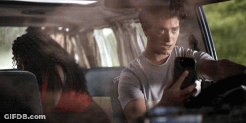 Man Looking At Phone While Driving GIF