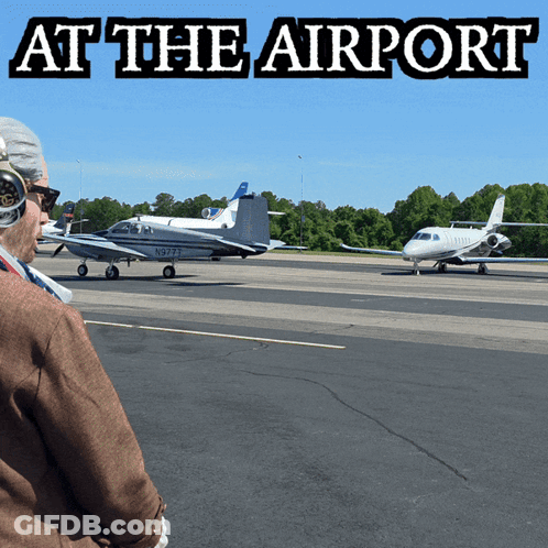 Man Looking At Plane At Airport GIF