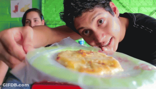 Man Looking At Plate Of Food While Woman Looks On GIF