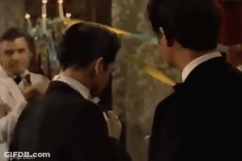 Man Looking At Reflection Holding Lighter GIF