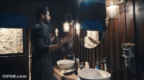 Man Looking At Reflection In Bathroom Mirror GIF