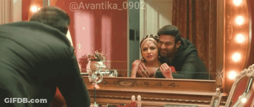 Man Looking At Woman In Mirror GIF