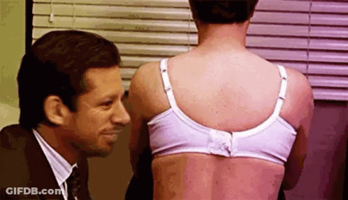 Man Looking At Woman's Back In Bra GIF