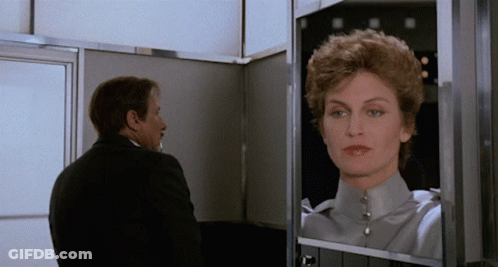 Man Looking At Woman's Reflection GIF