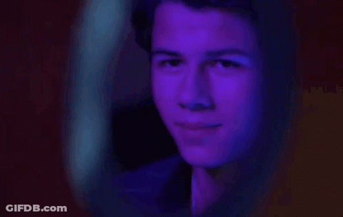 Man Looking In Mirror With Purple Light GIF