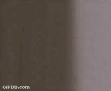 Man Looking Out Of Hole In Wall GIF