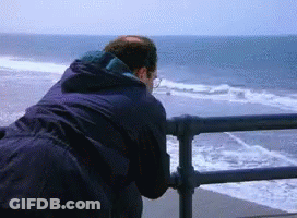 Man Looking Out Over Ocean From Pier GIF