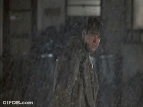 Man Looking Out Window At People Sitting At Tables In Rain GIF