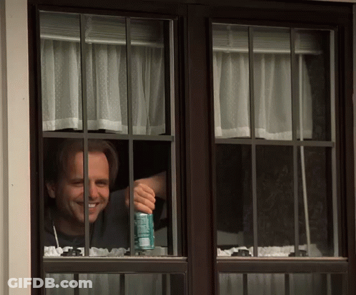 Man Looking Out Window Holding A Soda GIF