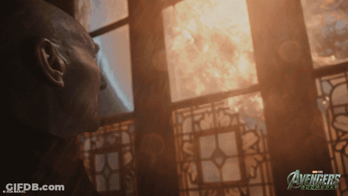 Man Looking Out Window With Avengers Logo GIF