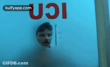 Man Looking Through Glass Door With UCI GIF