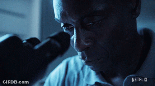 Man Looking Through Microscope With Netflix Logo GIF