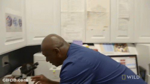 Man Looking Through Microscope With Wild Logo GIF