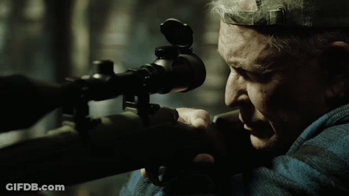 Man Looking Through Sniper Scope With Hat On Head GIF
