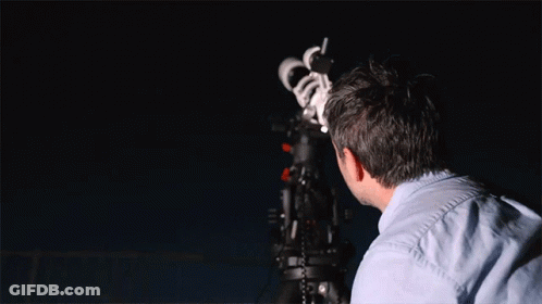 Man Looking Through Telescope At Night Sky GIF