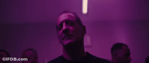 Man Looking Up In Dark Room With Purple Lights GIF