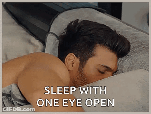 Man Lying In Bed Sleep With One Eye Open GIF