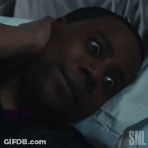 Man Lying In Bed With SNL Logo On Face GIF