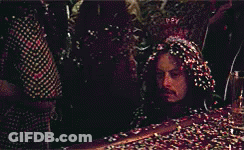 Man Lying In Confetti With Head Covered GIF