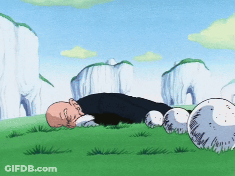 Man Lying In Grass Among Balls And Mountains GIF