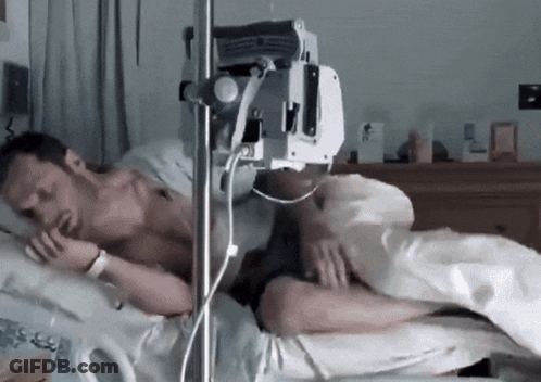 Man Lying In Hospital Bed With IV GIF