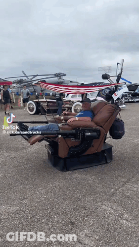 Man Lying In Recliner Parking Lot GIF