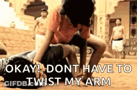 Man Lying On Another Saying Okay Don't Twist My Arm GIF
